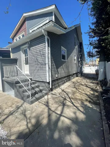 a view of a house with a wooden fence
