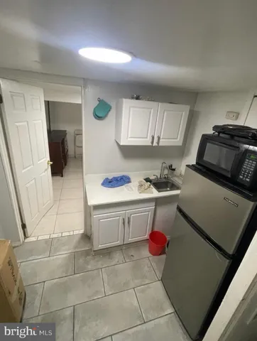 a kitchen with a sink cabinets and appliances