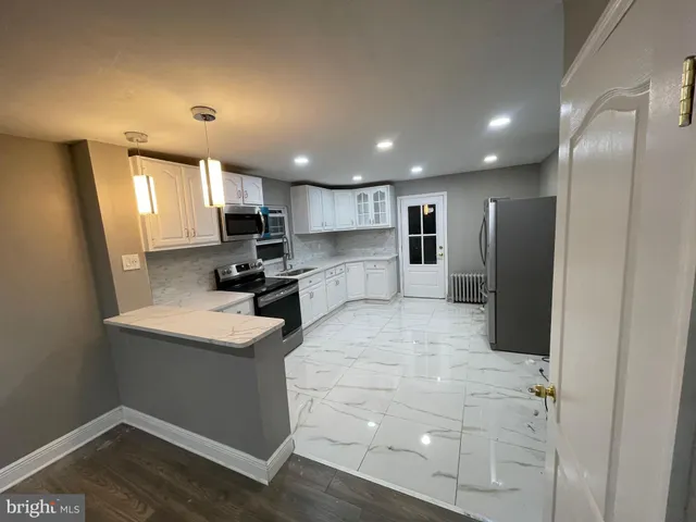 a kitchen with a refrigerator and a sink