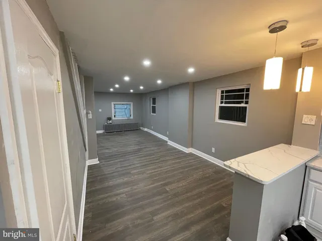 a view of a hallway to a house and wooden floor