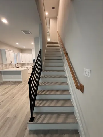 a view of entryway and hall with wooden floor