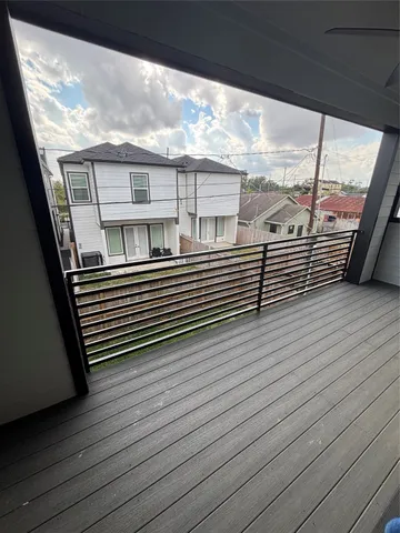 a view of a balcony with wooden floor