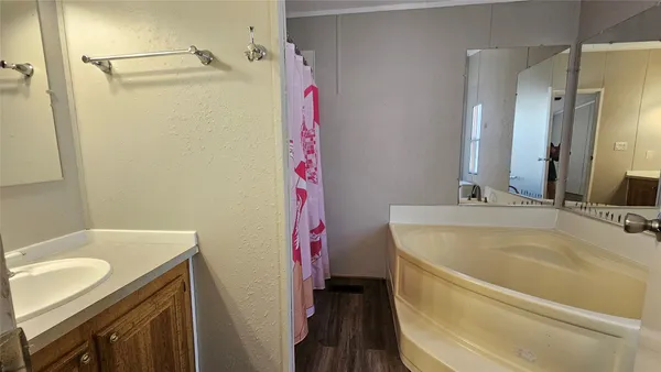 a bathroom with a tub and a sink