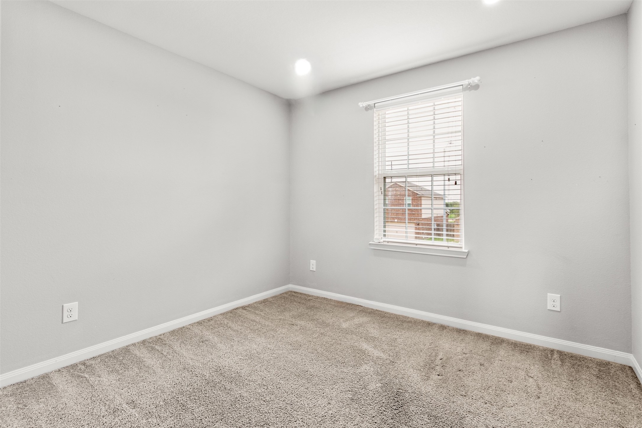 9426 Grand Spark Drive Rosharon, TX 77583 - Photo 18 of 31 This secondary bedroom offers a comfortable layout with soft natural light and neutral finishes. It is ideal for family members, guests, or even a dedicated workspace.