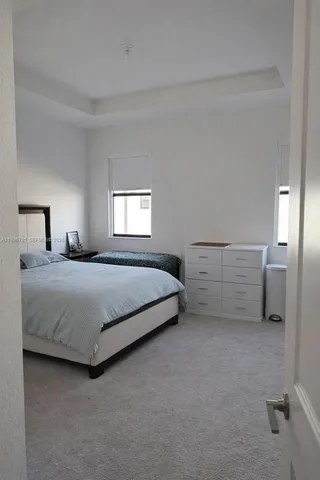 a bedroom with a bed and a night stand