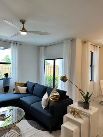 a living room with furniture and a window