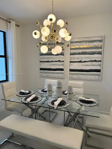 a table room with a table and a chandelier