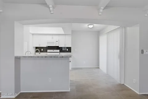a kitchen with white cabinets and white appliances