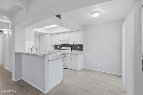 a kitchen with granite countertop a sink and stove