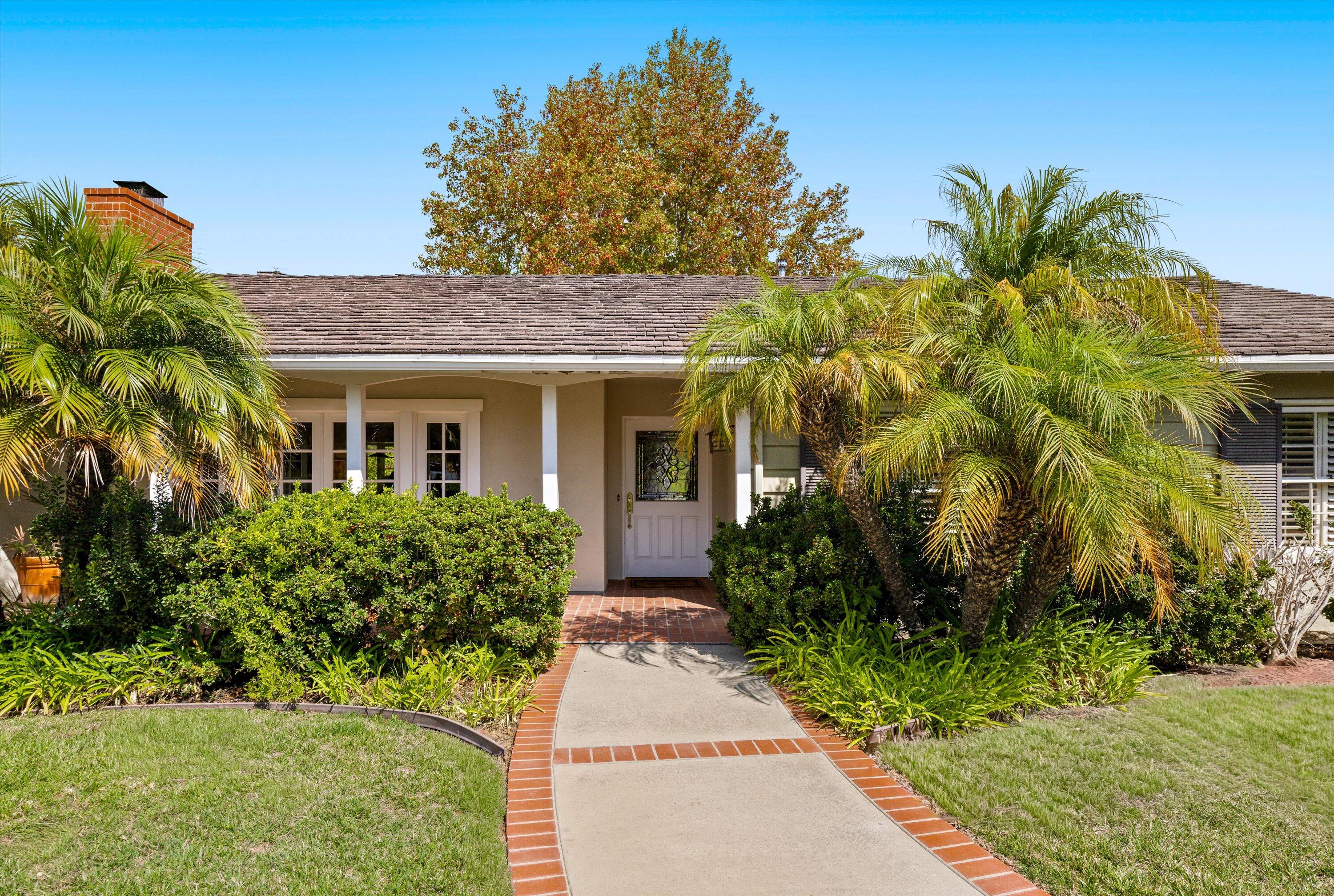 a front view of a house with a garden