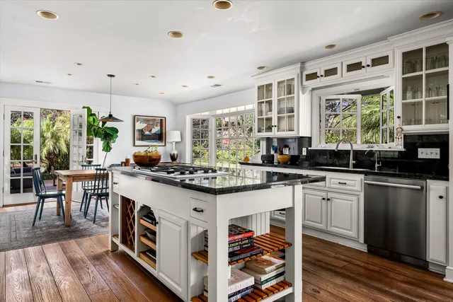a kitchen with granite countertop a stove a sink and a cabinets