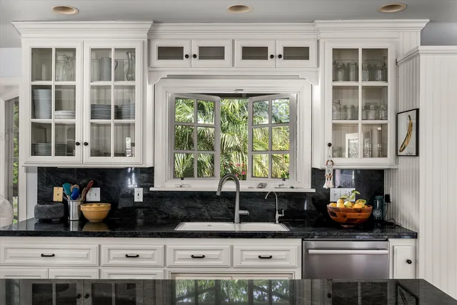 a kitchen with stainless steel appliances kitchen island granite countertop a stove and a sink