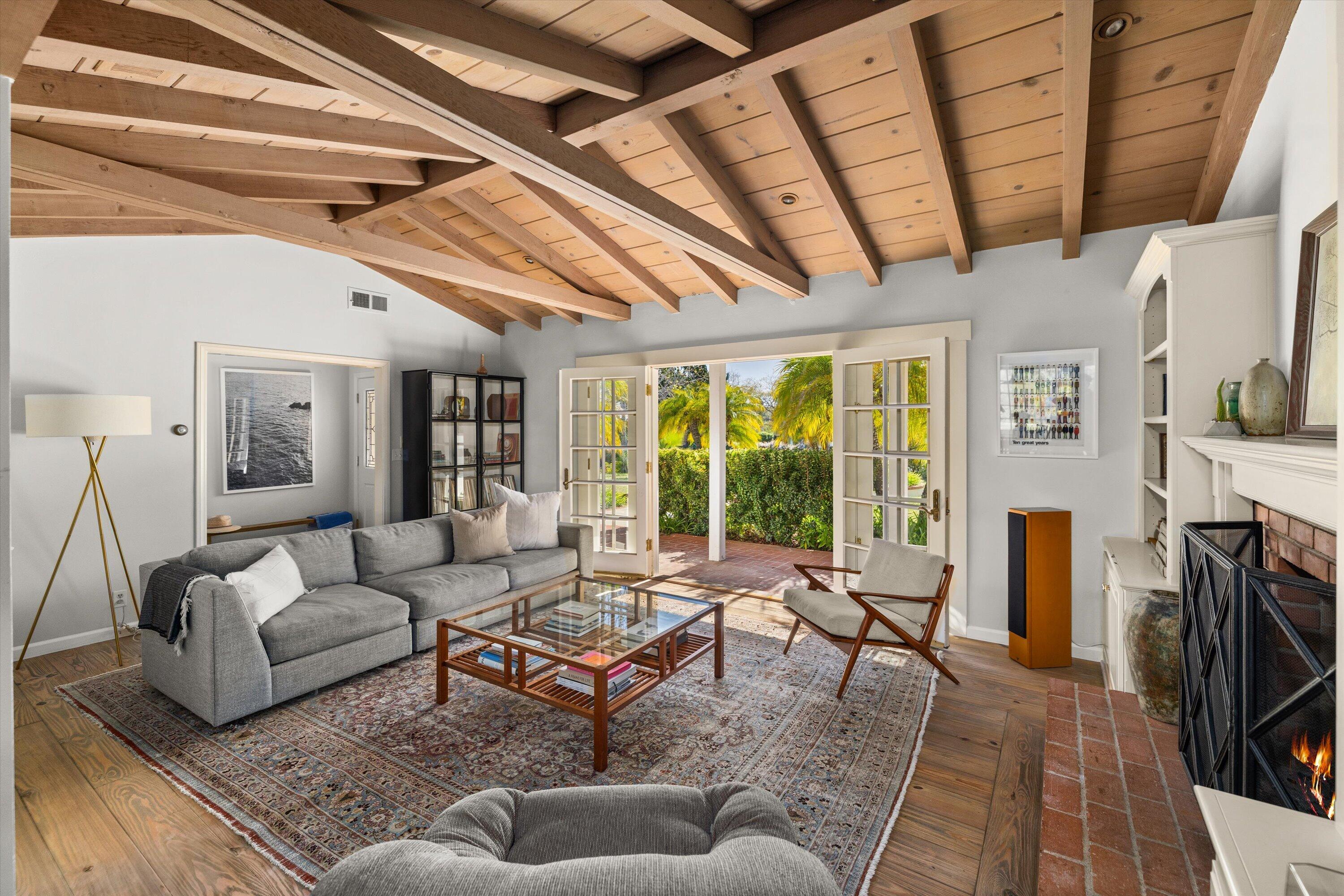 1192 Edward Place Goleta, CA 93111 - Photo 9 of 29 a living room with furniture a fireplace and a floor to ceiling window