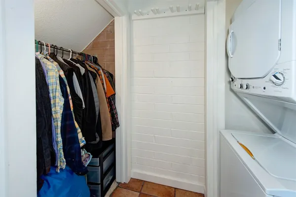 a view of a house with a wooden fence