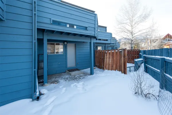 a view of backyard with wooden fence