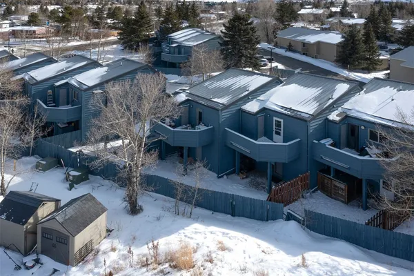 an aerial view of residential houses with a city view