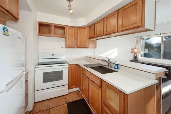 a kitchen with stainless steel appliances a stove sink and cabinets