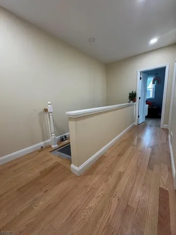 a view of a room with wooden floor
