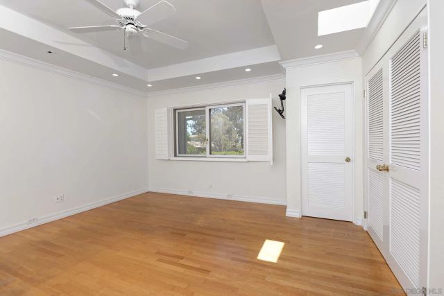 a view of a big room with wooden floor and windows in a room