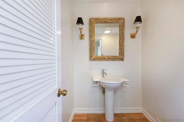 a bathroom with a sink a mirror and shower