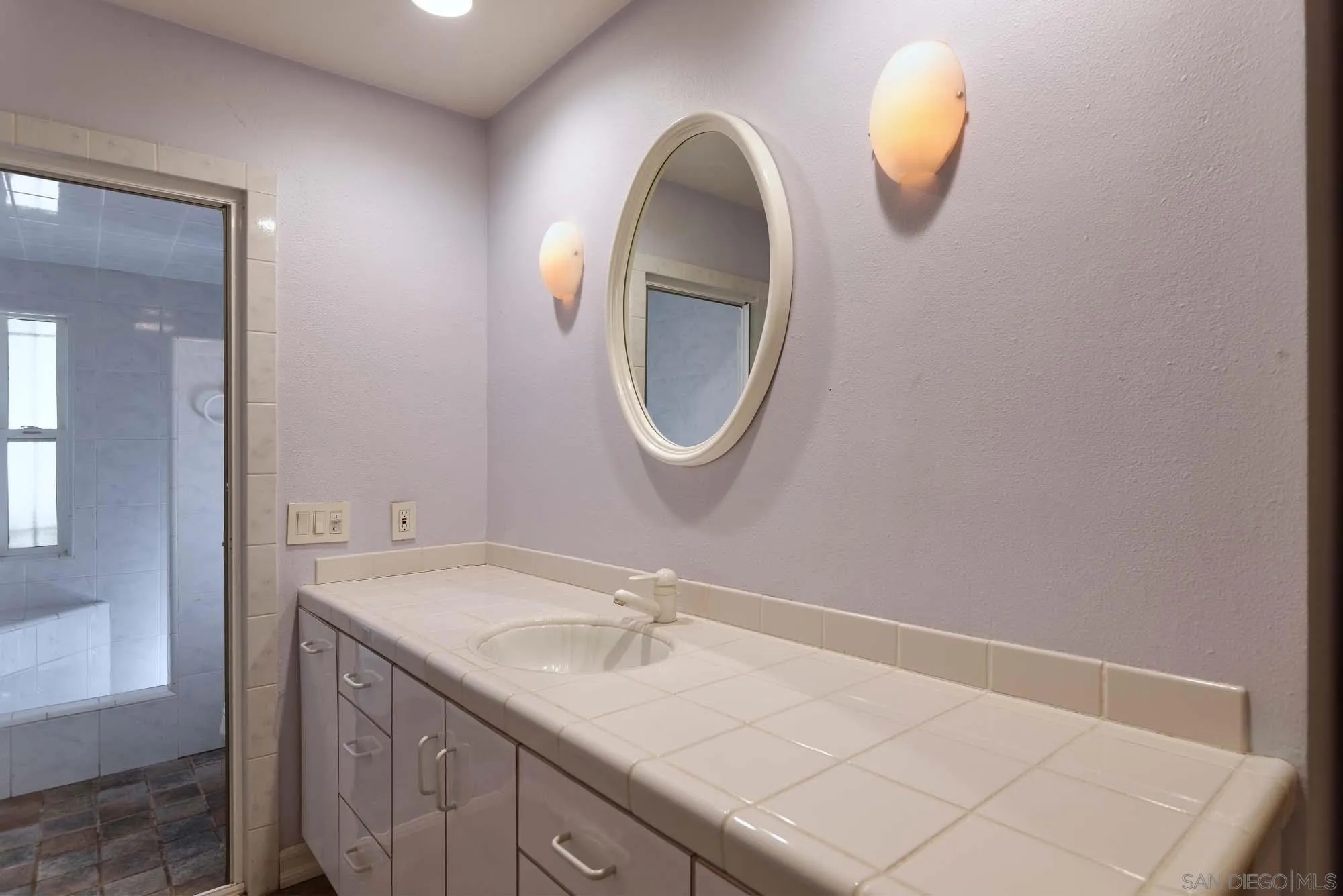 2075 Caminito Circulo Sur La Jolla, CA 92037 - Photo 16 of 26 a bathroom with a sink and a mirror