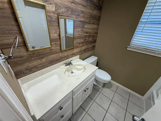 an empty room with a ceiling fan and a window