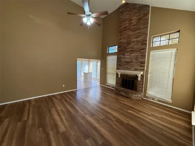 wooden floor in an empty room with a fireplace