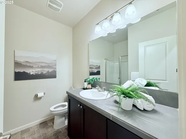 a bathroom with a sink a mirror and a toilet