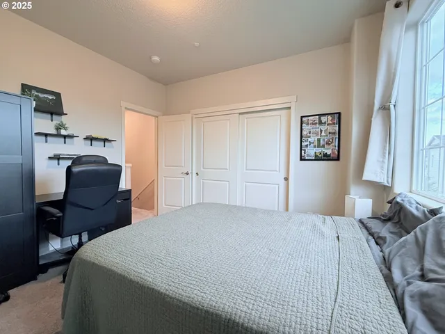 a bedroom with a bed furniture and a window