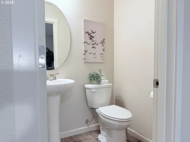 a bathroom with a sink toilet and a mirror