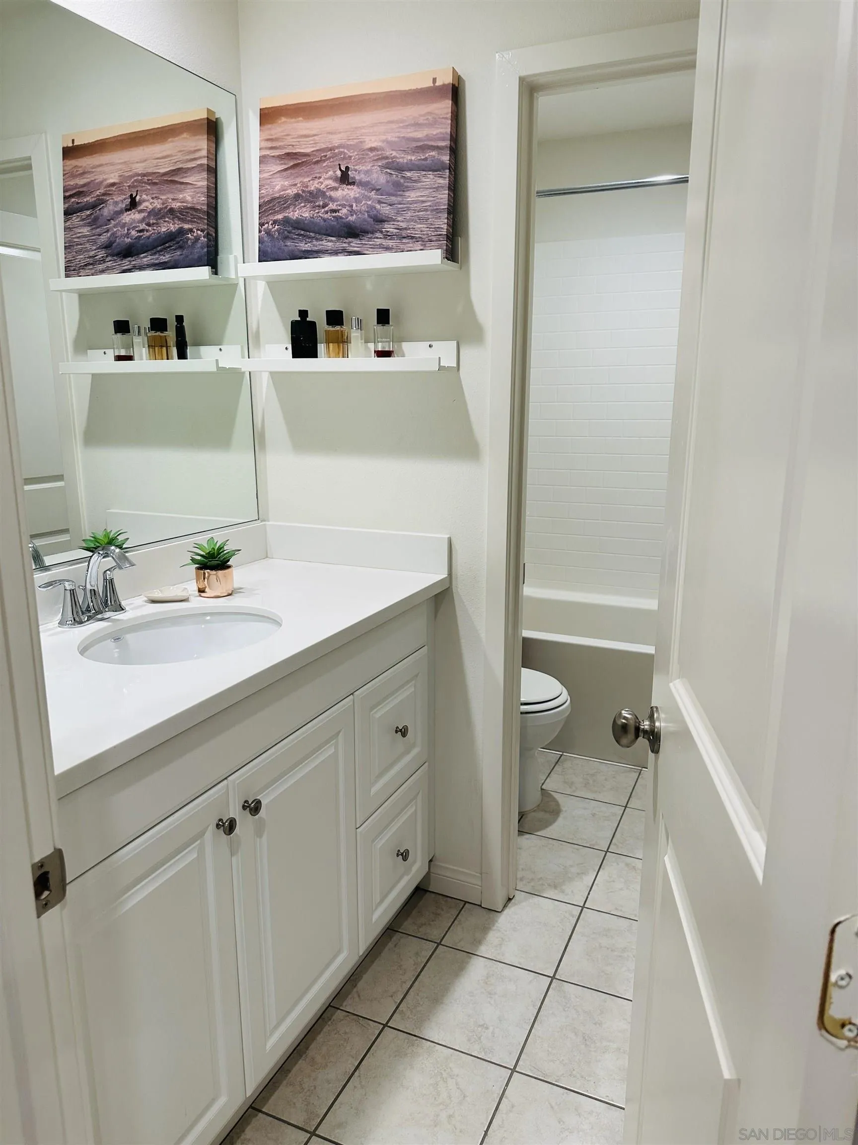4309 Star Path Way, Unit 2 Oceanside, CA 92056 - Photo 12 of 32 a bathroom with a sink mirror vanity and toilet