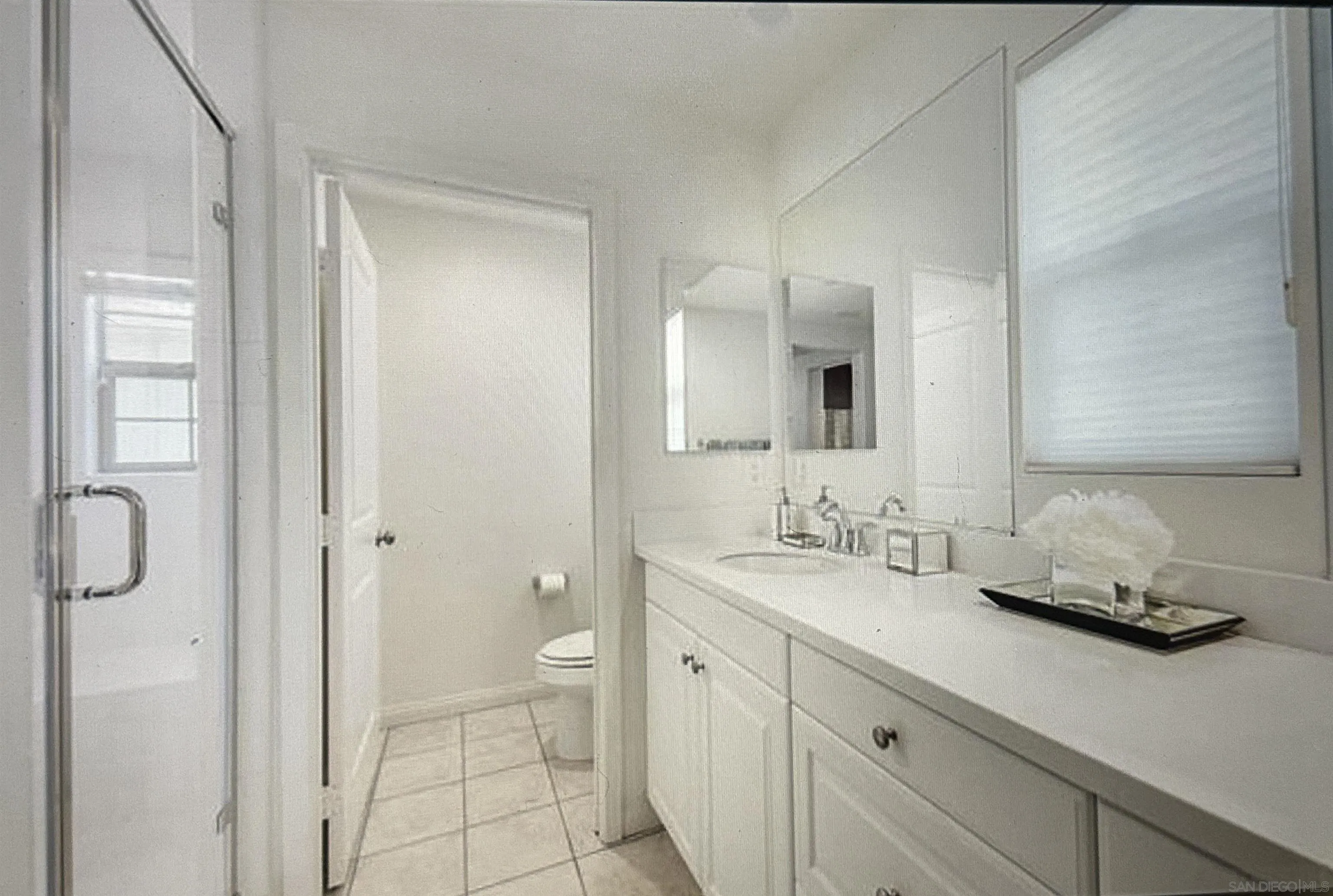 4309 Star Path Way, Unit 2 Oceanside, CA 92056 - Photo 13 of 32 a bathroom with a double vanity sink toilet and shower