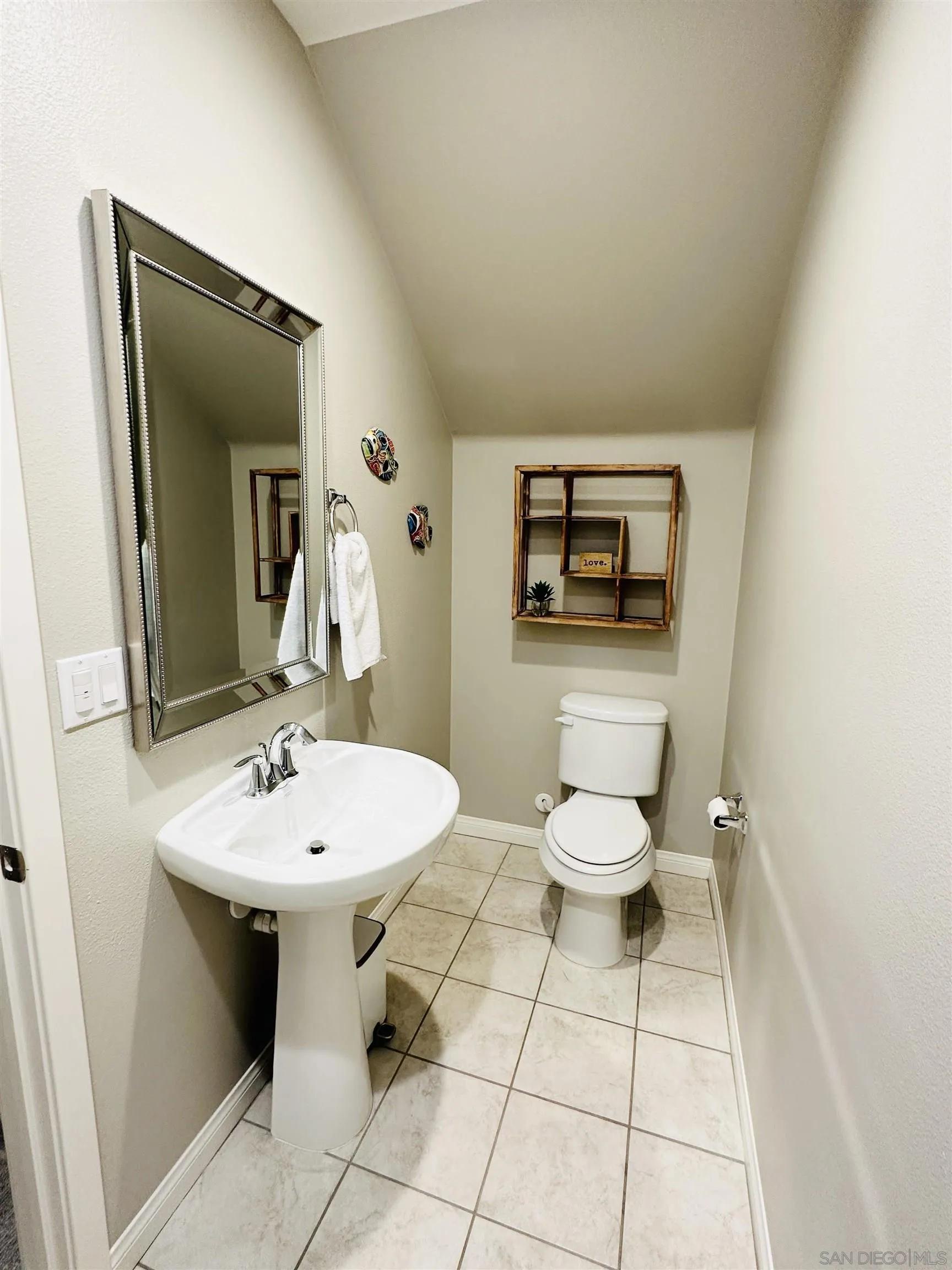 4309 Star Path Way, Unit 2 Oceanside, CA 92056 - Photo 16 of 32 a bathroom with a toilet sink and mirror
