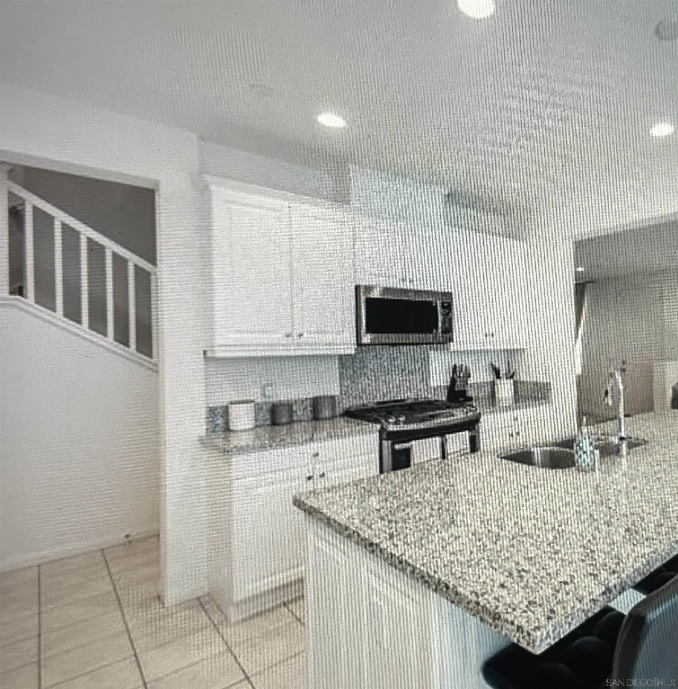 4309 Star Path Way, Unit 2 Oceanside, CA 92056 - Photo 2 of 32 a kitchen with granite countertop a sink and white cabinets