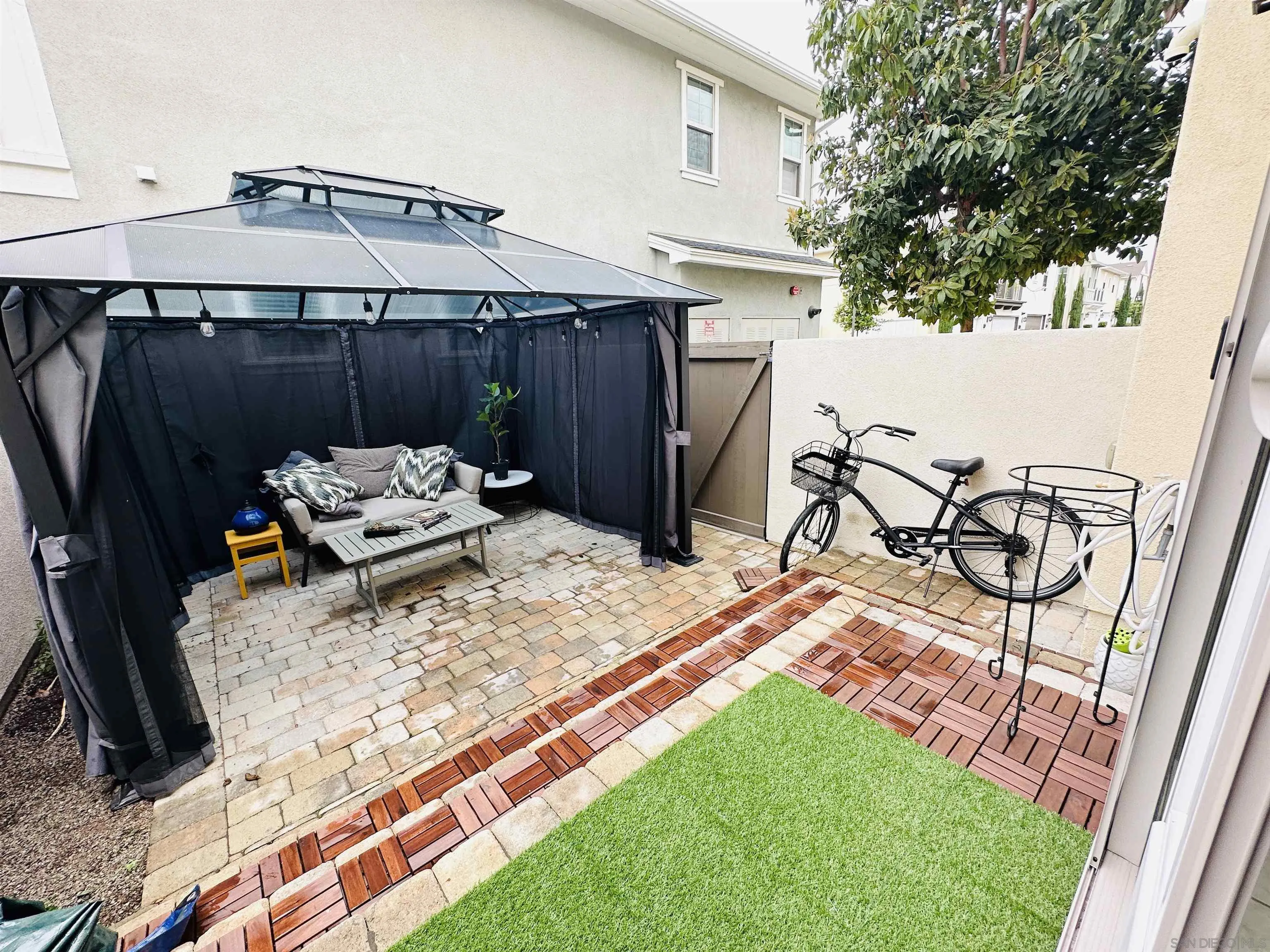 4309 Star Path Way, Unit 2 Oceanside, CA 92056 - Photo 21 of 32 a backyard of a house with table and chairs