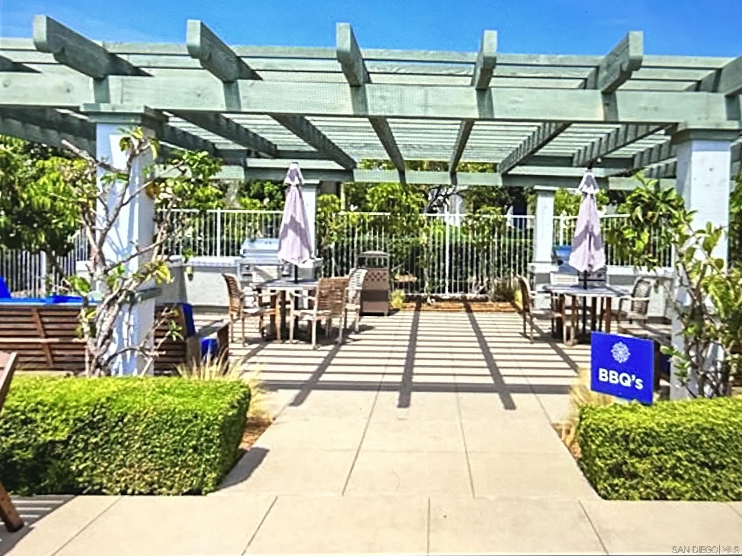 4309 Star Path Way, Unit 2 Oceanside, CA 92056 - Photo 27 of 32 a view of a patio with table and chairs potted plants