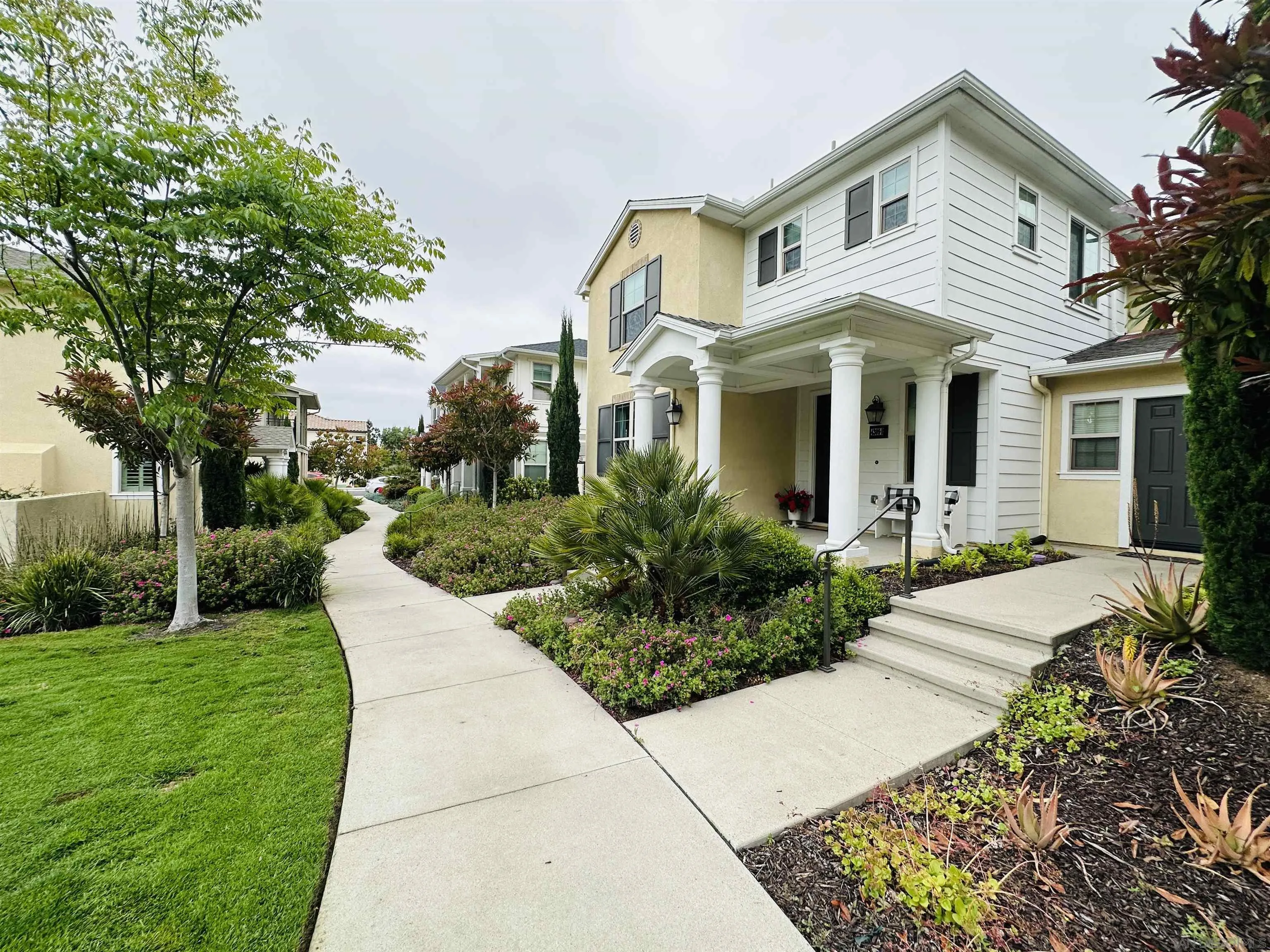4309 Star Path Way, Unit 2 Oceanside, CA 92056 - Photo 30 of 32 a front view of house with yard and green space