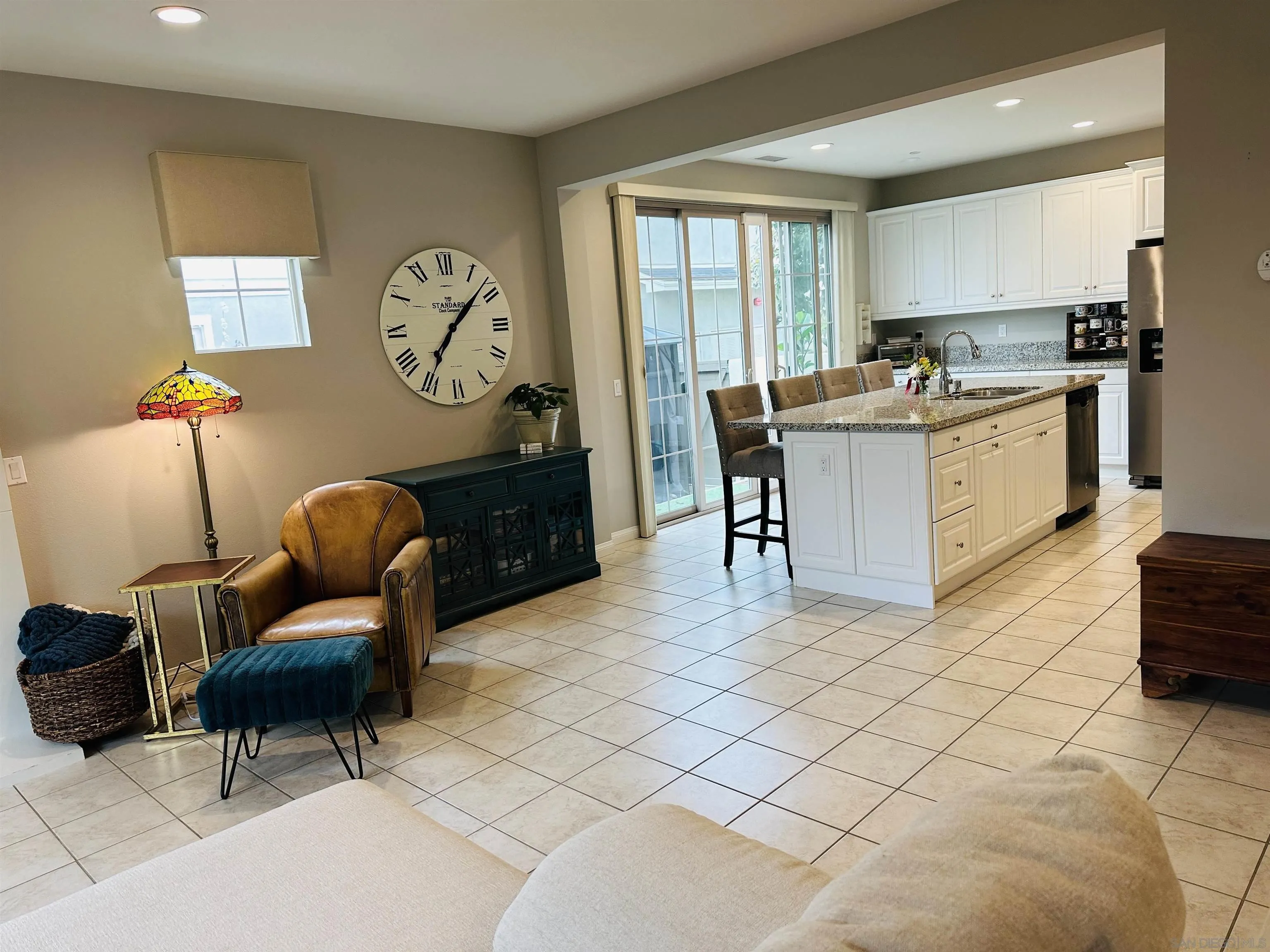 4309 Star Path Way, Unit 2 Oceanside, CA 92056 - Photo 7 of 32 a living room with furniture a clock and a window