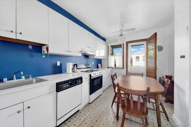 a kitchen with a white cabinets and white appliances