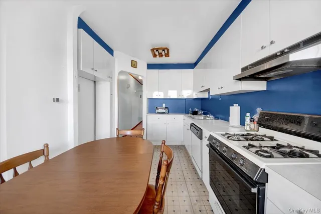 a kitchen with a stove a sink and a refrigerator