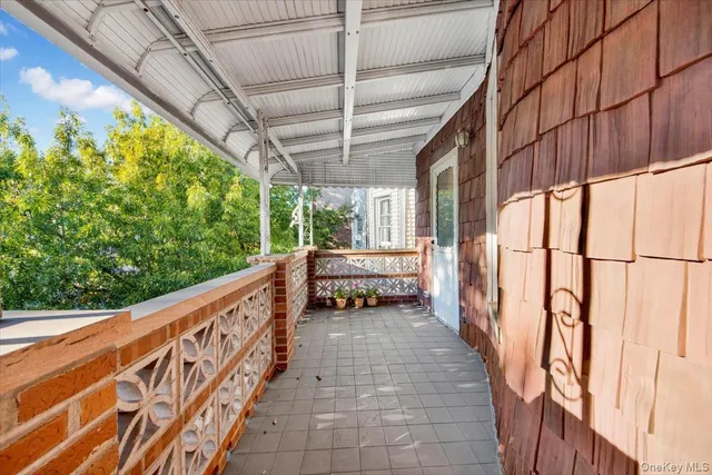 a view of balcony with wooden floor and furniture