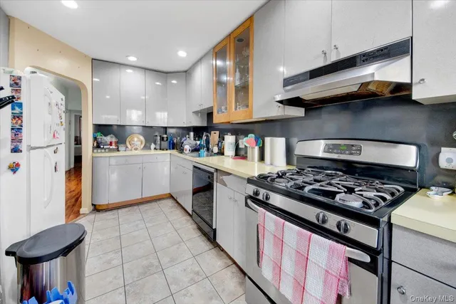 a kitchen with stainless steel appliances granite countertop a stove and a refrigerator
