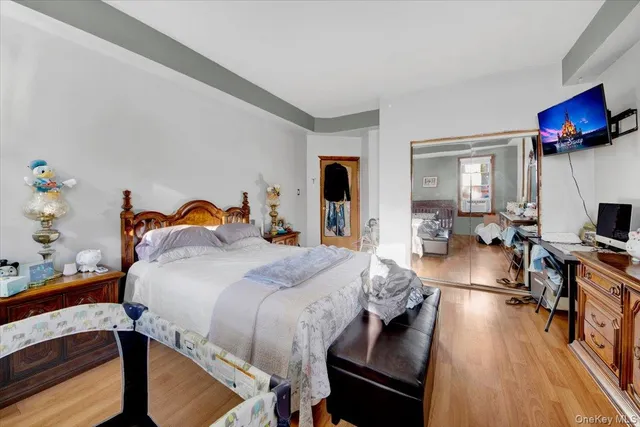 a bedroom with a bed and a wooden floor