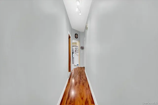 a view of a hallway with a white wall