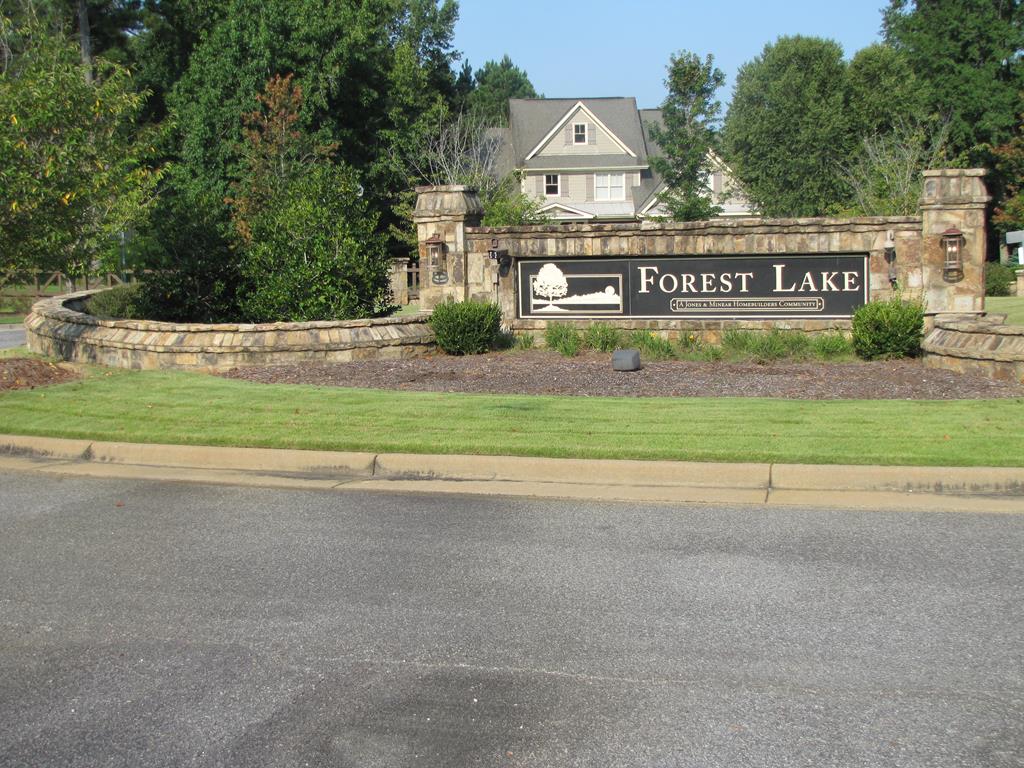 7715 Lynch Road Midland, GA 31820 - Photo 26 of 32 a front view of a house with a garden and parking