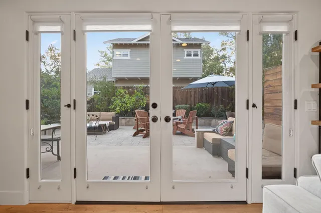 a view of living room filled with furniture and chandelier