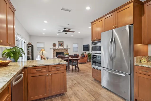 a kitchen with kitchen island a counter top space stainless steel appliances and cabinets
