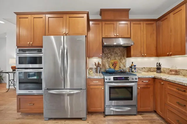 a kitchen with appliances and cabinets