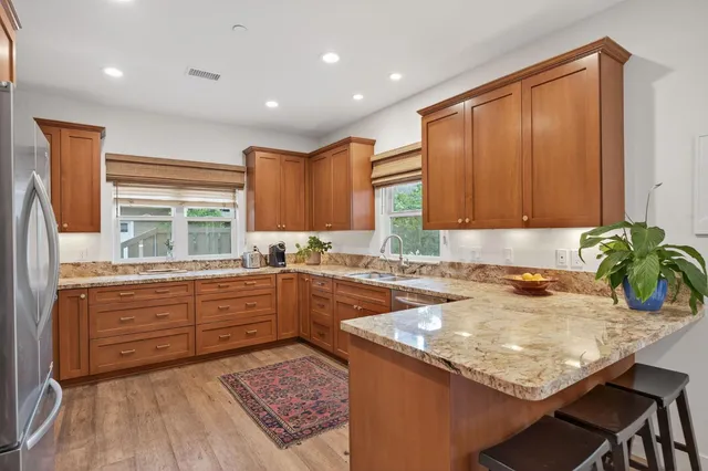 a kitchen with a stove a sink and a refrigerator