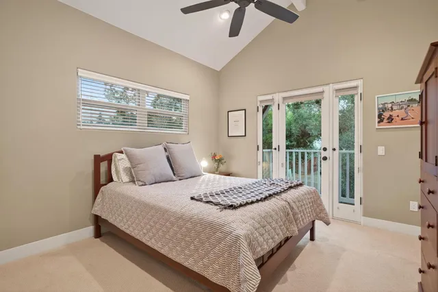 a bedroom with a large bed and a window